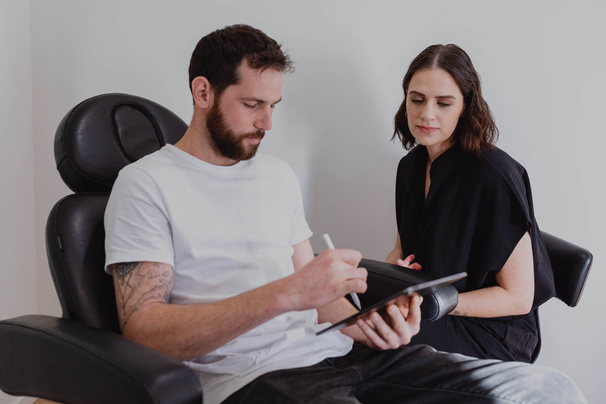 Jasmine talking through a treatment plan with a client at Reform Skin Studio